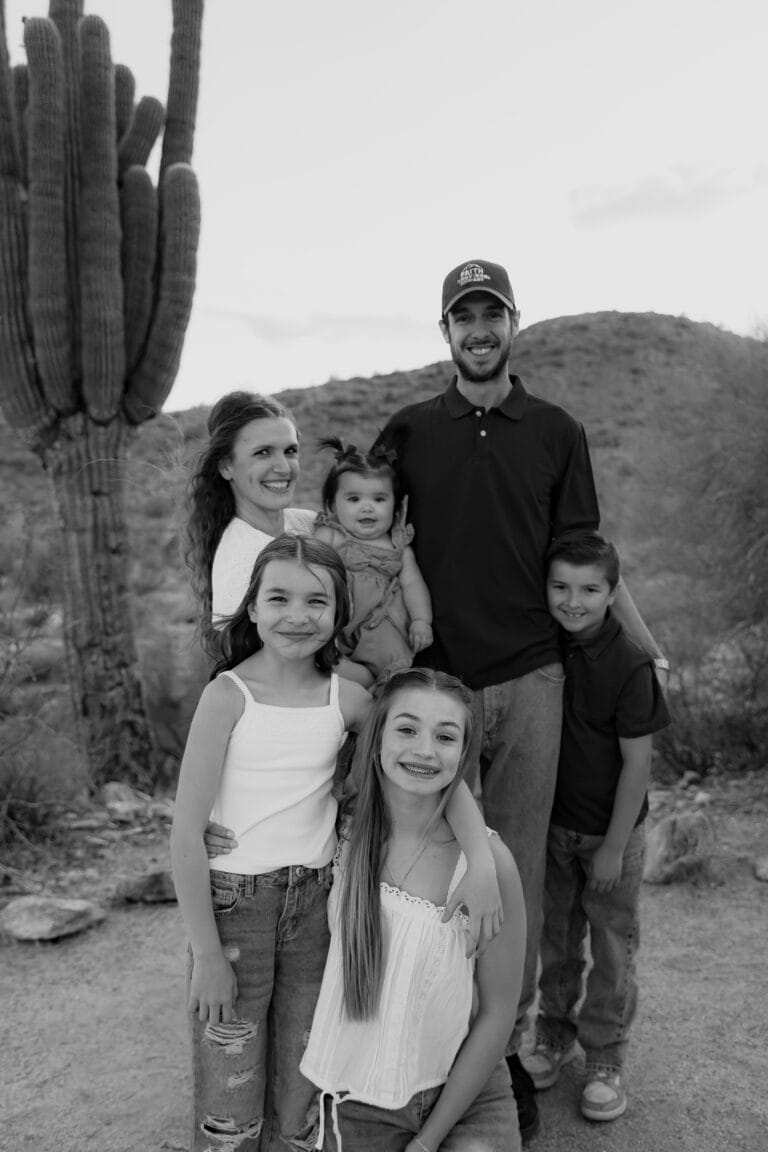 Rambo 121 Movers founder Oscar Ramirez with his wife and children in the Arizona desert, representing the family behind the business